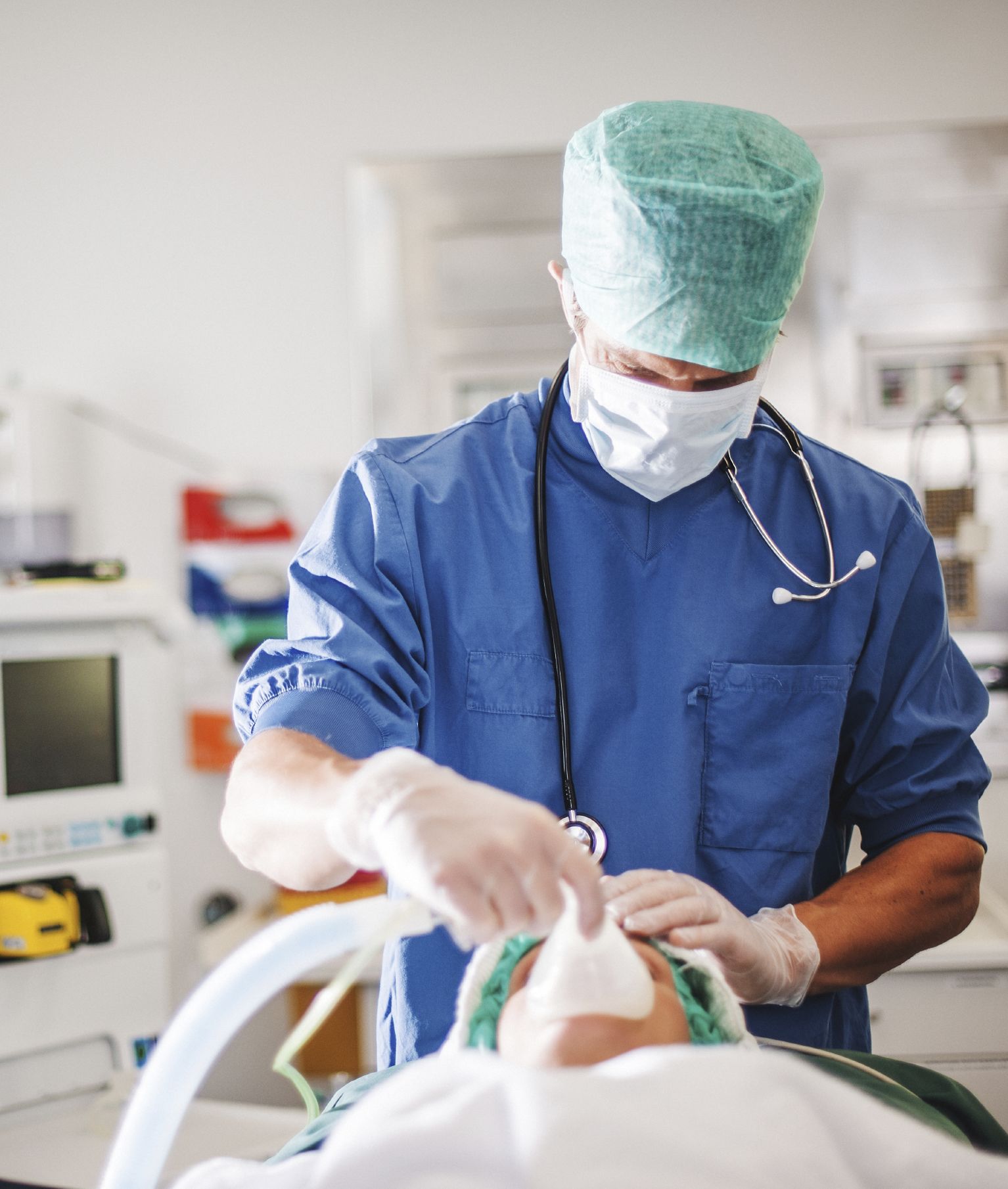 Doctor administering anesthesia to patient